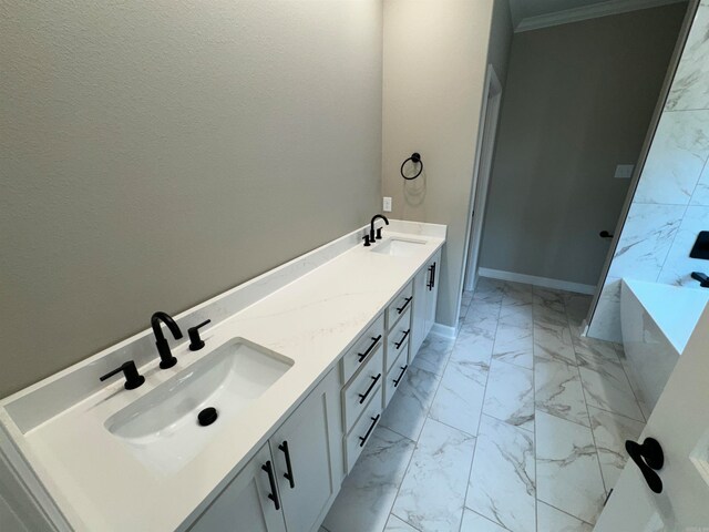 bathroom with vanity, a bathtub, and ornamental molding