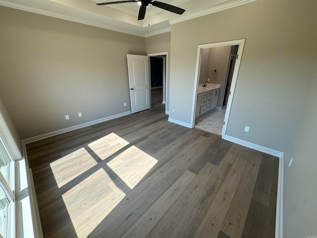 unfurnished bedroom featuring connected bathroom, ceiling fan, light hardwood / wood-style floors, and ornamental molding