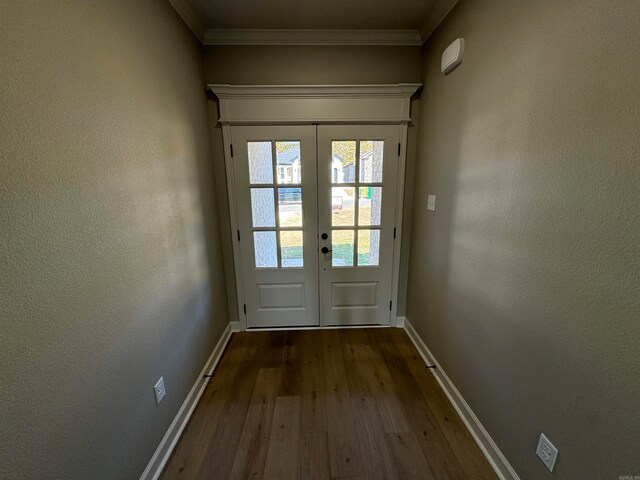 doorway with french doors, dark wood-type flooring, and ornamental molding