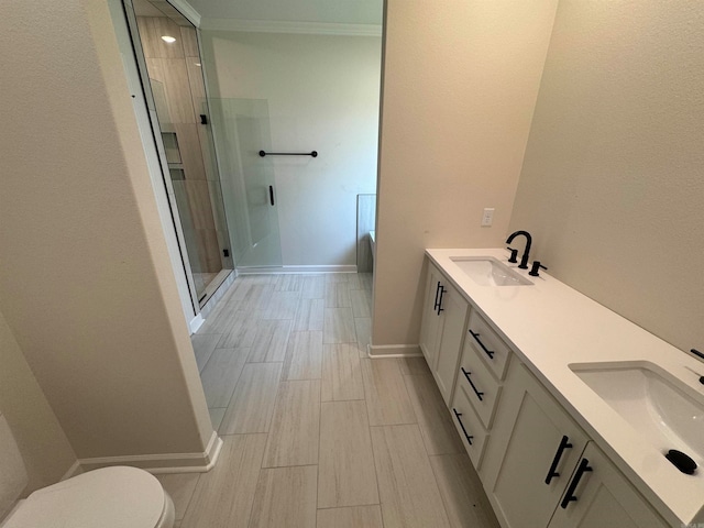 bathroom featuring vanity, toilet, and an enclosed shower