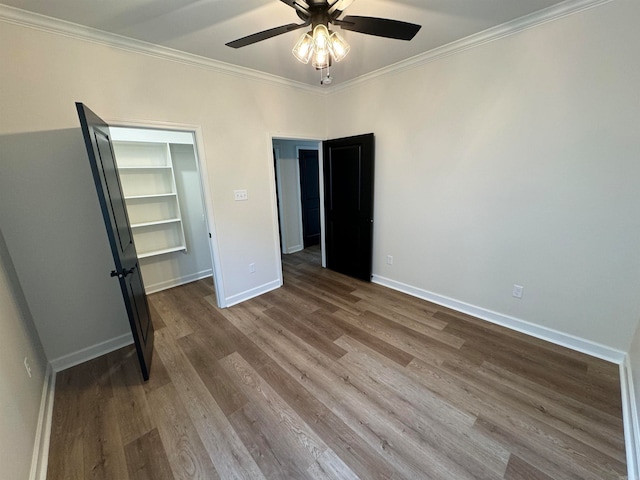 unfurnished bedroom with hardwood / wood-style flooring, crown molding, and ceiling fan