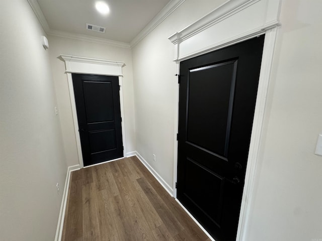 doorway to outside featuring crown molding and hardwood / wood-style floors