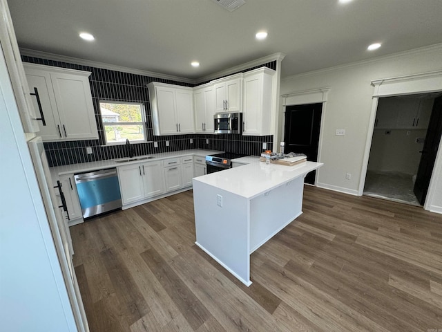 kitchen with stainless steel appliances, dark hardwood / wood-style floors, sink, and white cabinetry