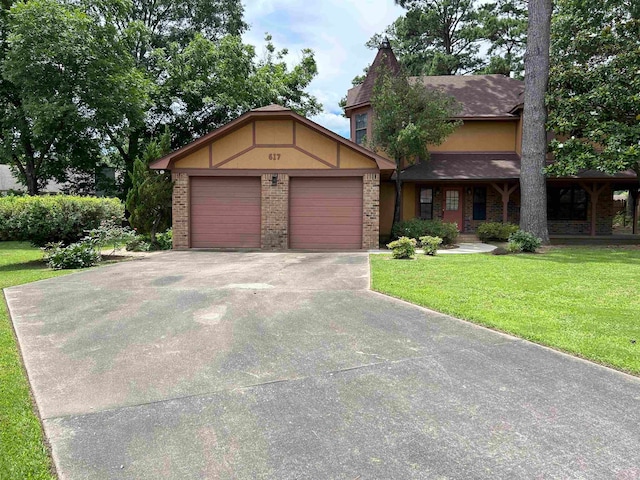 view of front of home with a garage and a front lawn