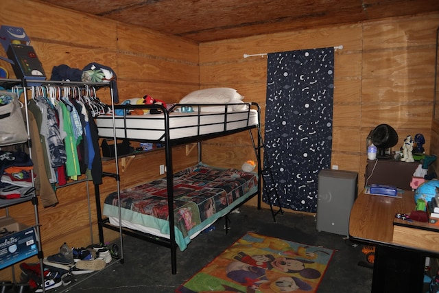 bedroom featuring wooden walls