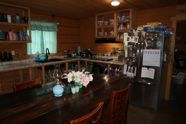 dining space featuring wooden walls, sink, and wooden ceiling