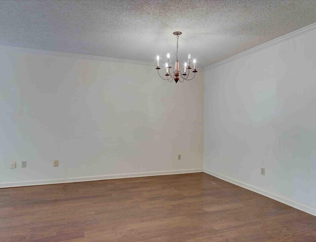 unfurnished room with dark wood-type flooring, a textured ceiling, and ornamental molding