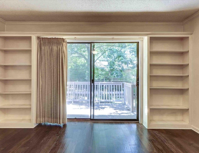 doorway to outside with dark hardwood / wood-style floors and a textured ceiling