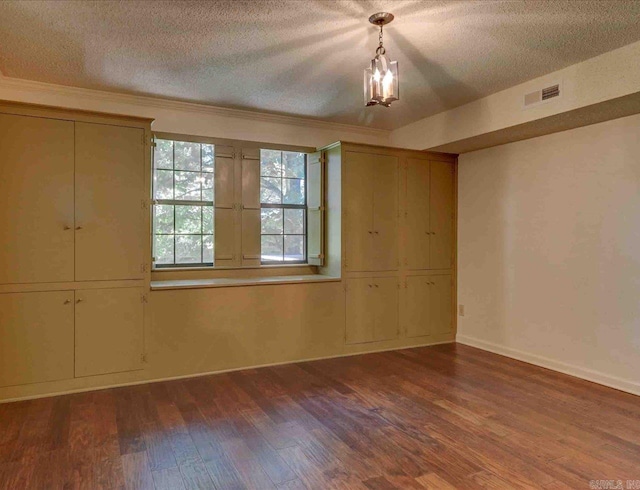 unfurnished bedroom featuring a textured ceiling and dark hardwood / wood-style flooring