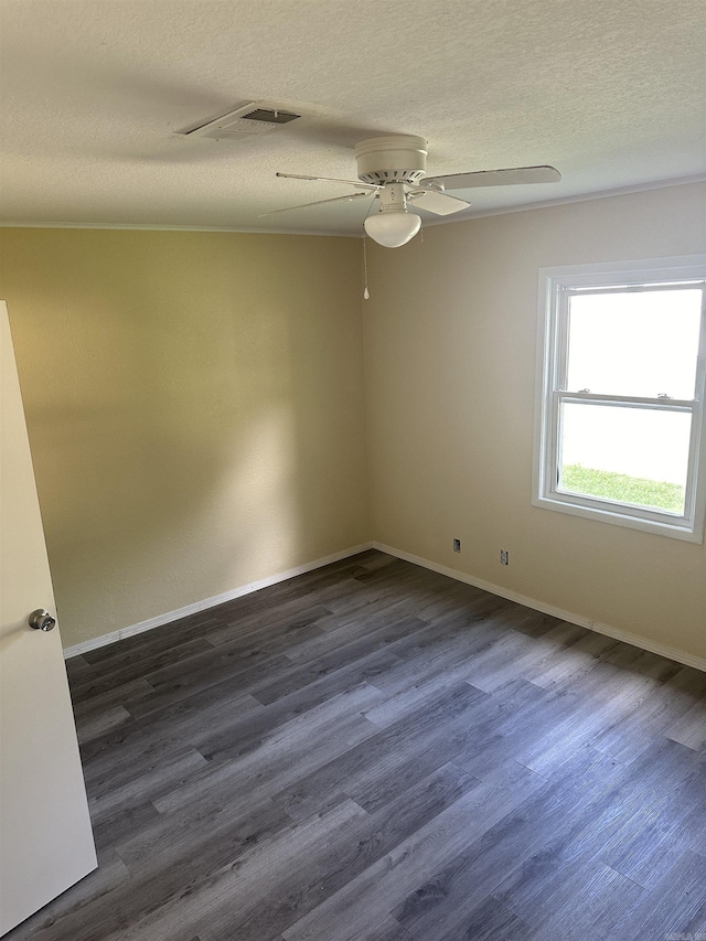 spare room with a textured ceiling, ceiling fan, and dark hardwood / wood-style floors