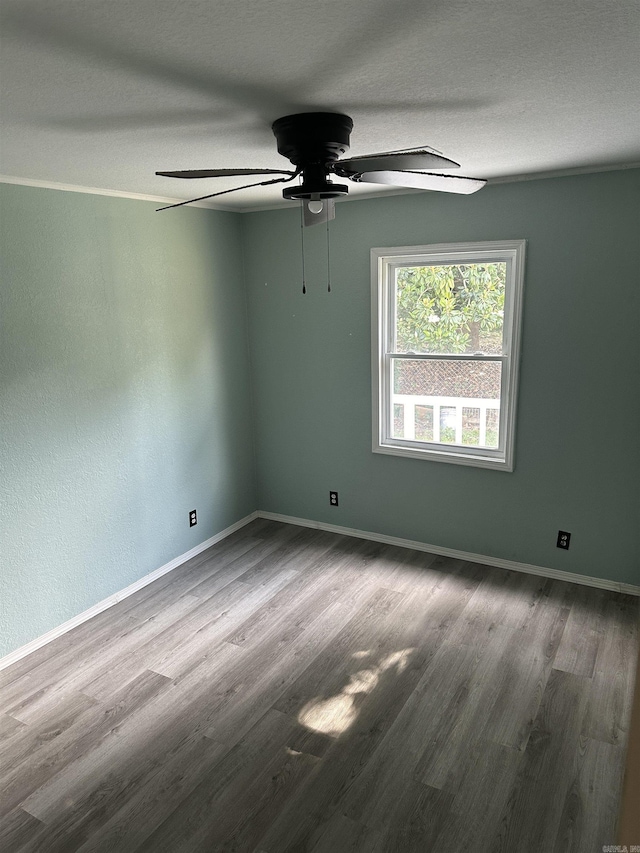 unfurnished room featuring ceiling fan, wood-type flooring, and a textured ceiling