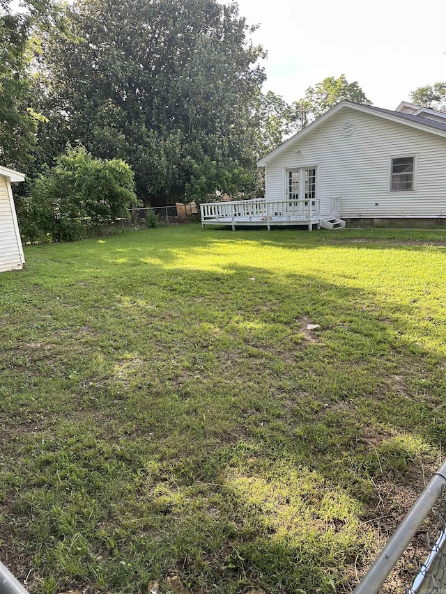 view of yard with a wooden deck