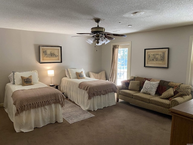 bedroom with ceiling fan, a textured ceiling, and dark colored carpet