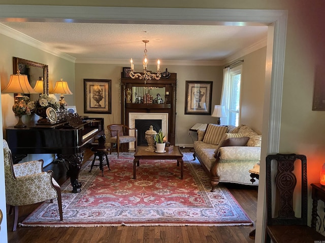 living room featuring hardwood / wood-style floors, ornamental molding, a textured ceiling, and a notable chandelier