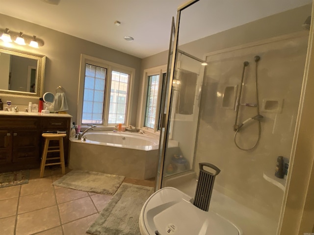 bathroom with plus walk in shower, vanity, and tile patterned floors