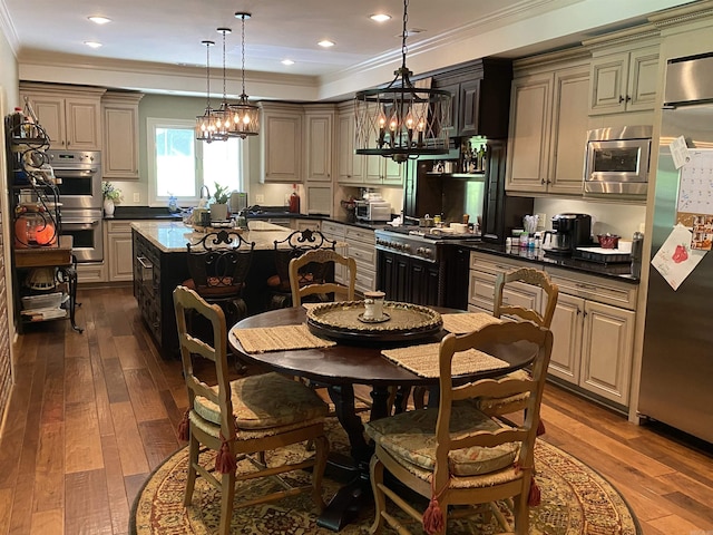 kitchen featuring pendant lighting, dark hardwood / wood-style floors, a kitchen island, and appliances with stainless steel finishes