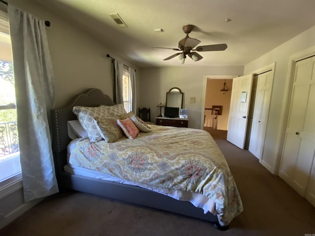 bedroom featuring multiple closets and ceiling fan