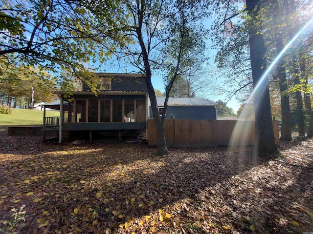 rear view of house featuring a deck and a sunroom