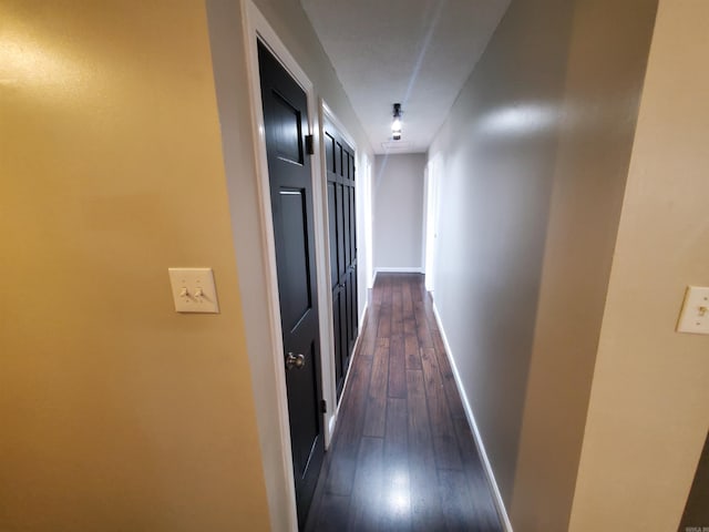 hallway with dark wood-type flooring