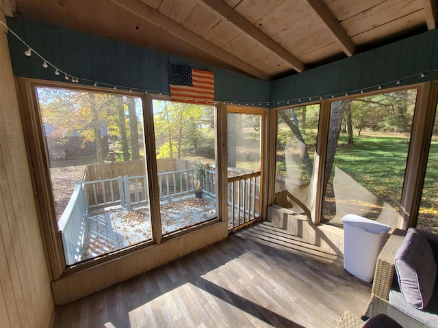 unfurnished sunroom with lofted ceiling with beams and wooden ceiling