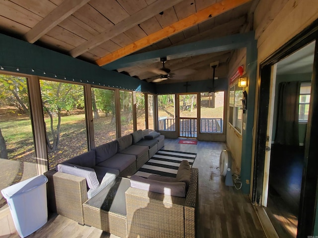 sunroom / solarium with vaulted ceiling with beams, ceiling fan, and wooden ceiling