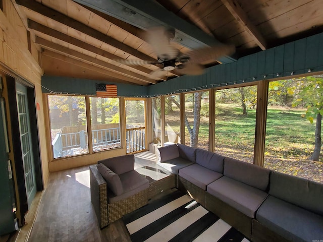 sunroom / solarium with lofted ceiling with beams, ceiling fan, and wooden ceiling