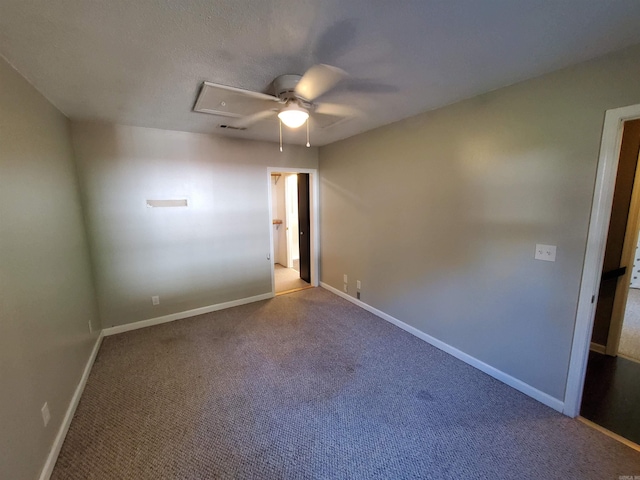 carpeted spare room featuring ceiling fan