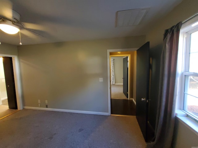 carpeted spare room with ceiling fan