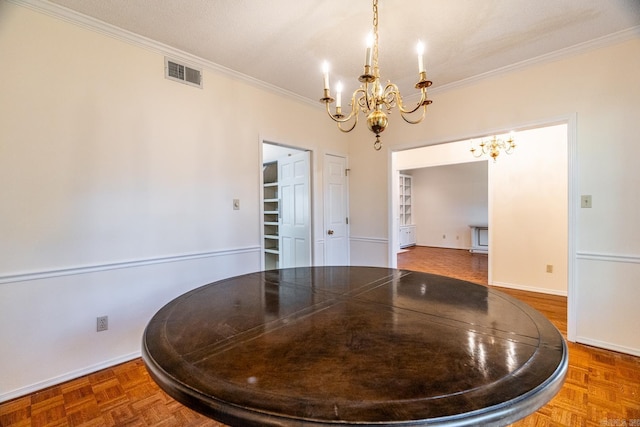 dining space featuring parquet flooring, crown molding, and a notable chandelier