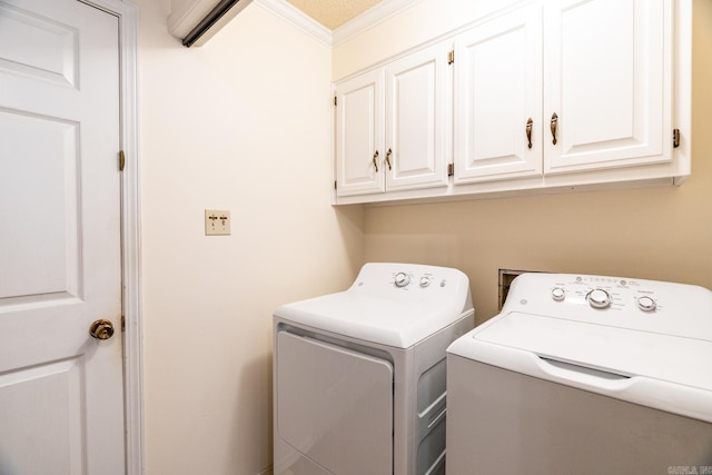 laundry room with separate washer and dryer, crown molding, and cabinets