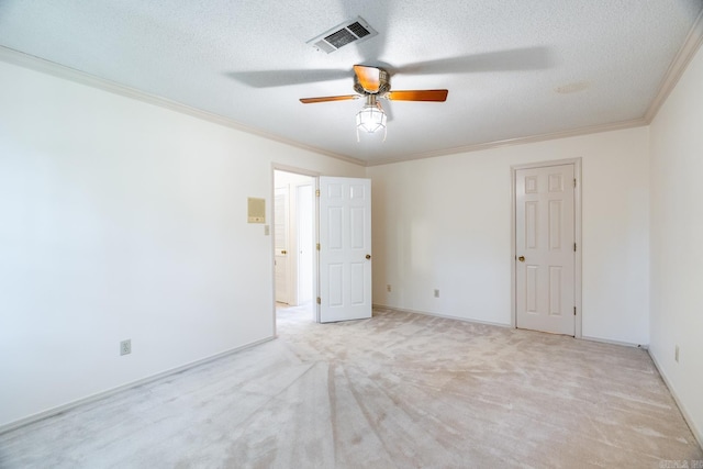 unfurnished room with crown molding, ceiling fan, light carpet, and a textured ceiling