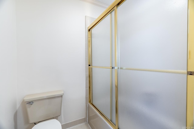 bathroom with ornamental molding, bath / shower combo with glass door, and toilet