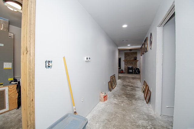 corridor with concrete floors and brick wall