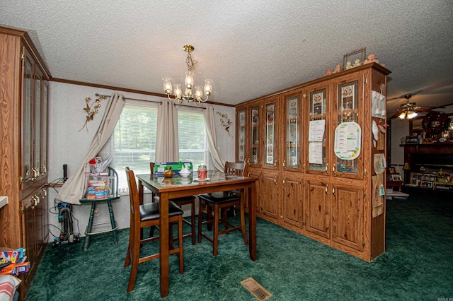 dining area featuring crown molding, ceiling fan with notable chandelier, a textured ceiling, and dark colored carpet