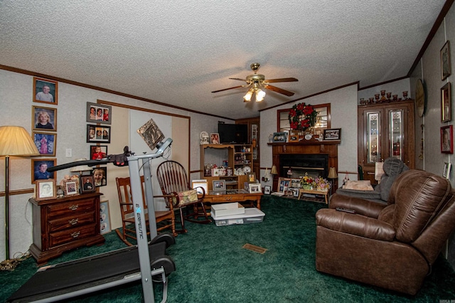 workout room featuring ceiling fan, carpet, a textured ceiling, and ornamental molding