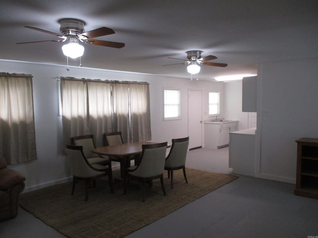 dining area featuring ceiling fan and sink