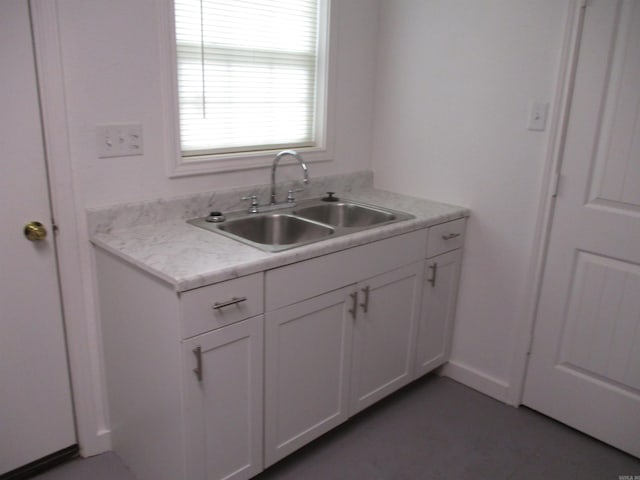 kitchen featuring white cabinets and sink