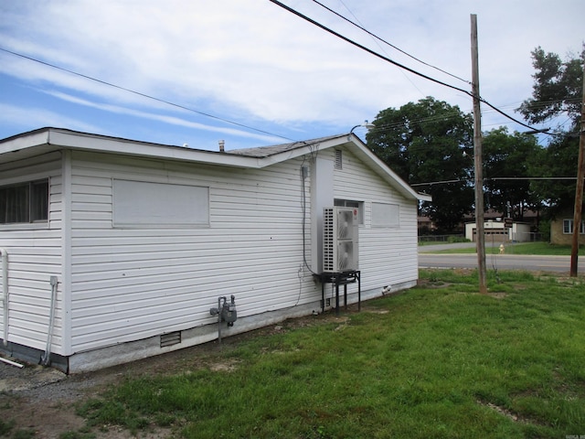 view of side of home featuring a yard