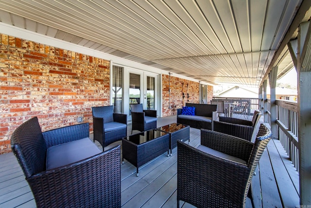 wooden terrace featuring outdoor lounge area and french doors