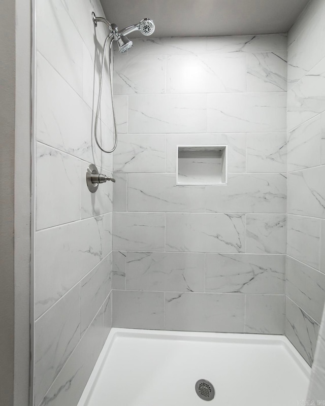 bathroom with a tile shower