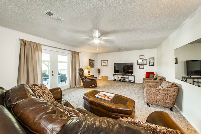 living room with carpet flooring, a textured ceiling, french doors, and ceiling fan