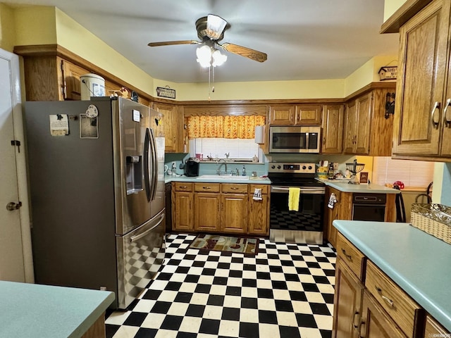 kitchen featuring stainless steel appliances, ceiling fan, and sink