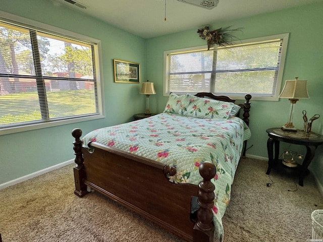 carpeted bedroom with multiple windows