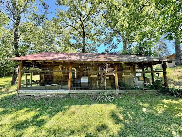 rear view of house with a lawn