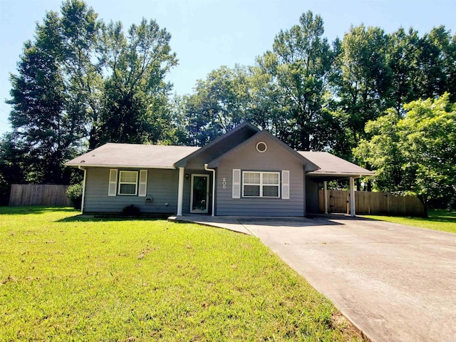 ranch-style house featuring a carport, driveway, a front lawn, and fence