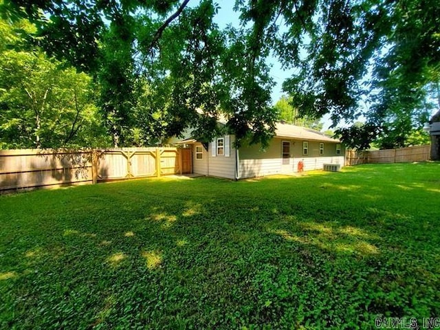 view of yard featuring a fenced backyard and cooling unit