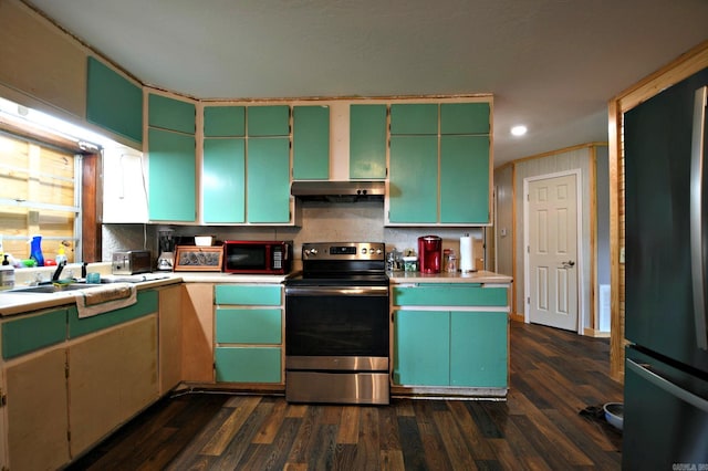 kitchen featuring stainless steel electric range oven, light countertops, range hood, freestanding refrigerator, and dark wood-style floors