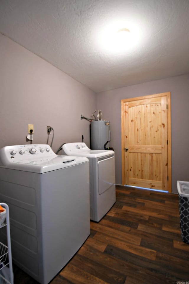 clothes washing area with electric dryer hookup, dark wood-type flooring, washing machine and dryer, and electric water heater