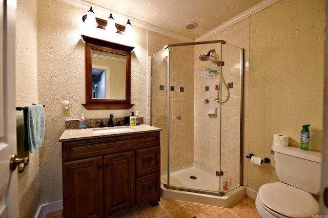 bathroom featuring vanity, a shower stall, crown molding, toilet, and a textured wall