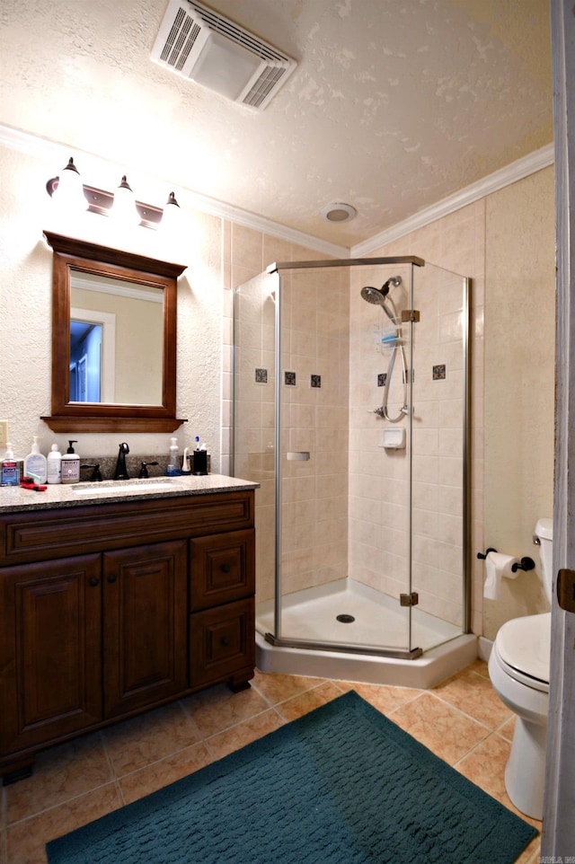 bathroom featuring a textured ceiling, tile floors, an enclosed shower, vanity with extensive cabinet space, and toilet